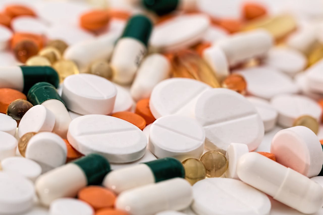 services-02 Close-up of various pills and capsules in different colors and sizes, ideal for healthcare-related content.